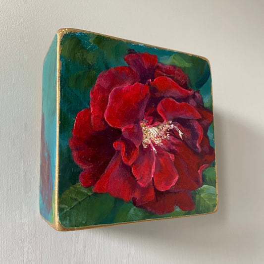 Square decorative box with a red floral design on a white background
