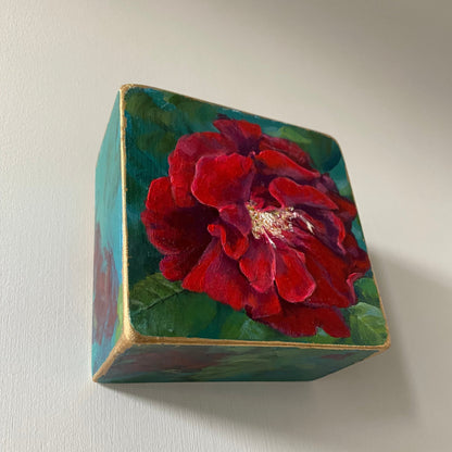 Decorative box with a red flower design on a light gray background